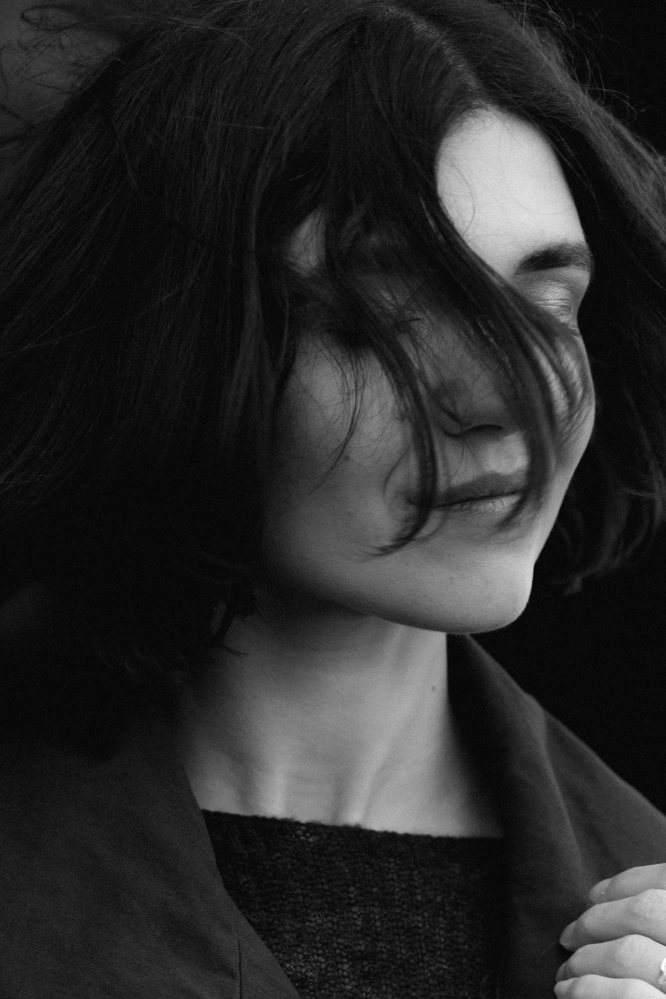 Cinematic black-and-white portrait by the sea