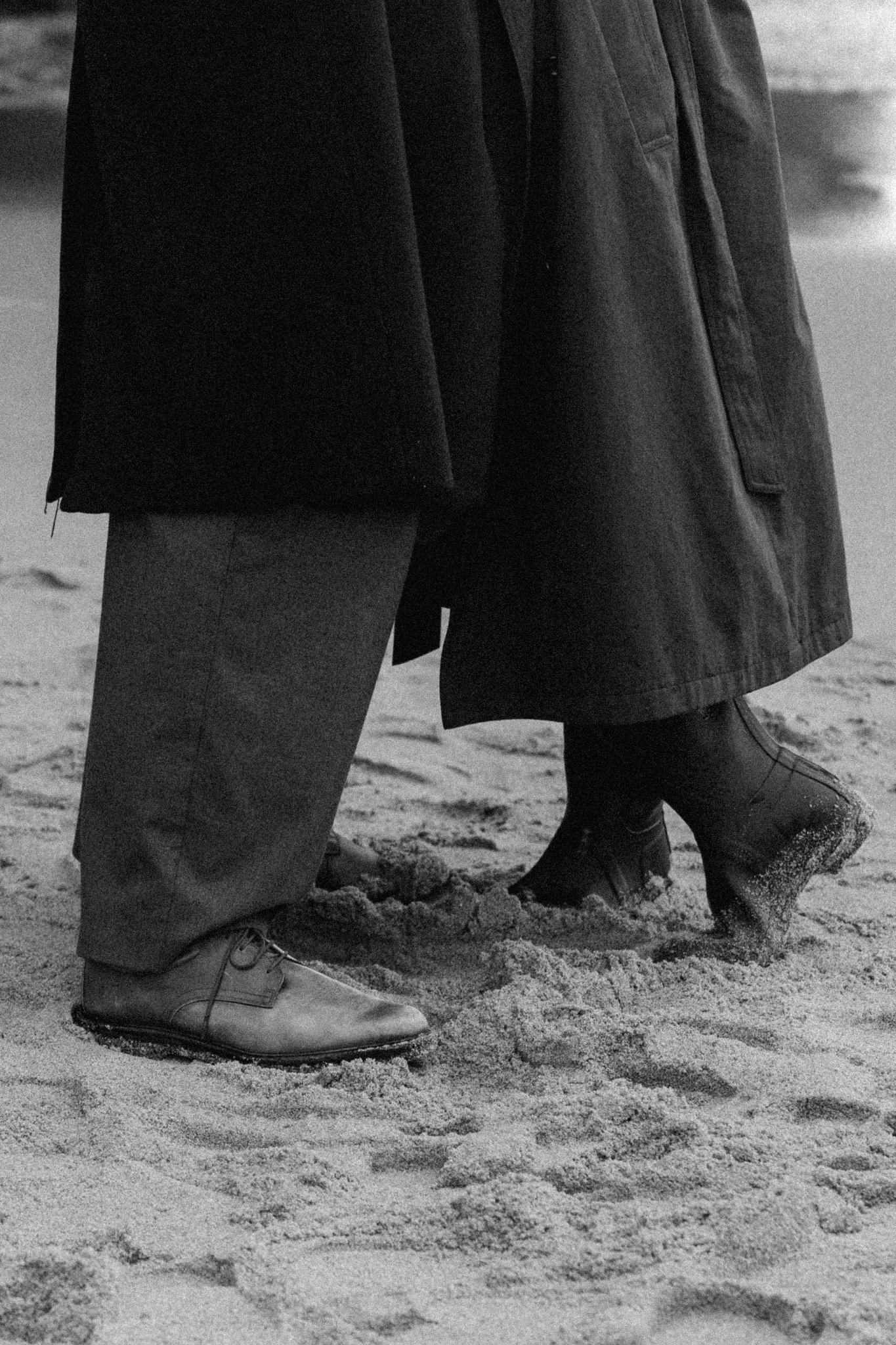 Couple walking barefoot on the sand