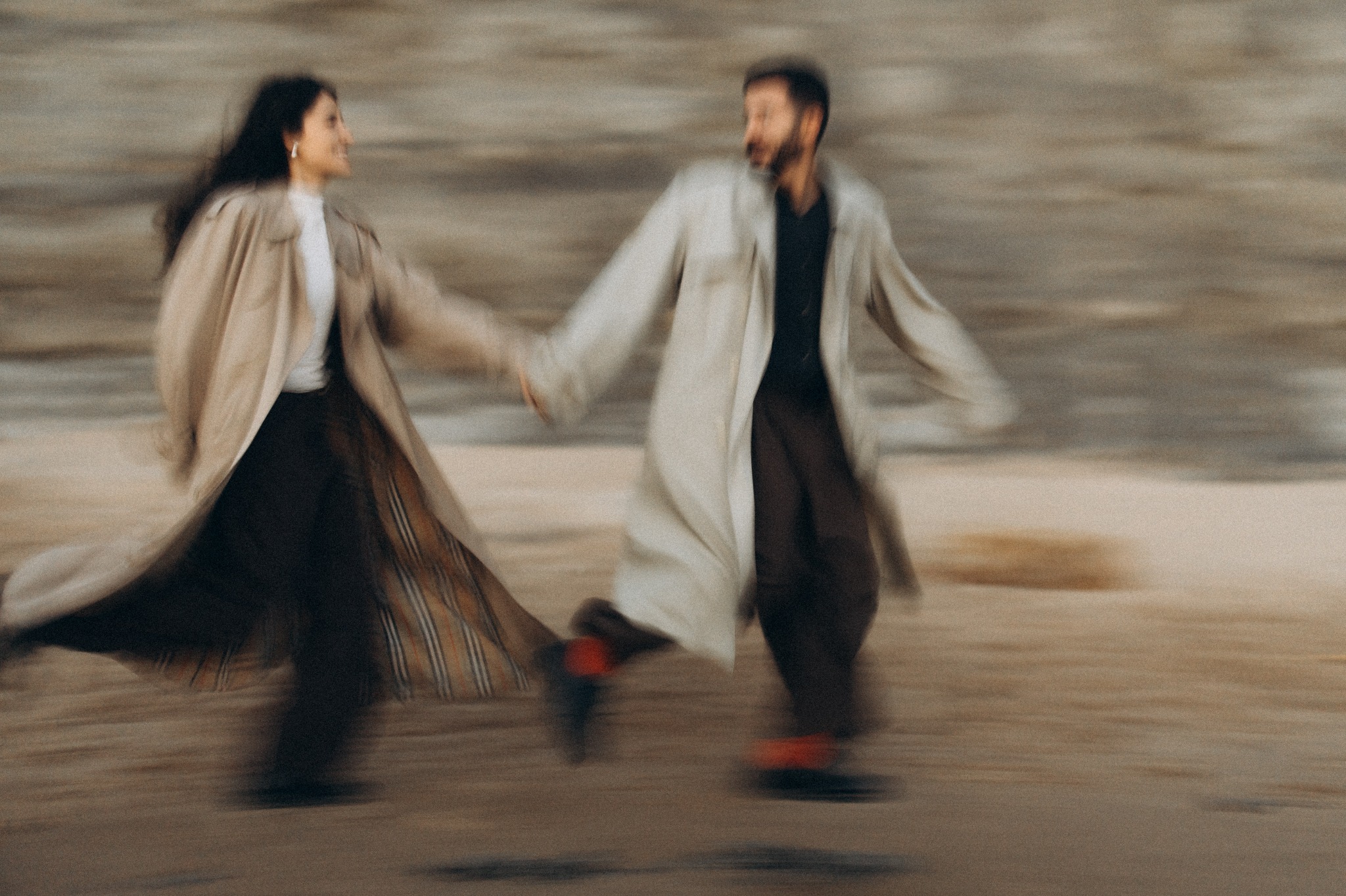 Couple running together on the beach